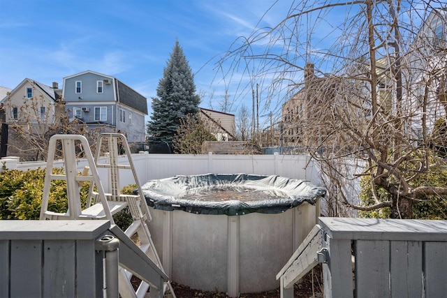 view of yard with fence and a fenced in pool