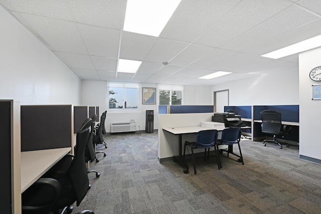 office featuring an AC wall unit, a paneled ceiling, and dark carpet