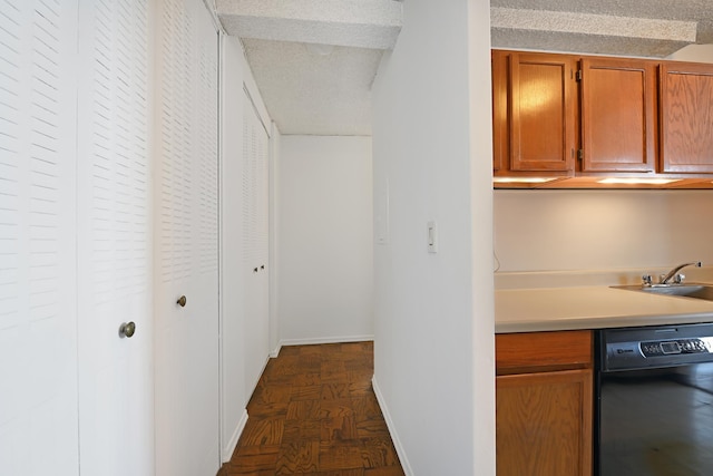 kitchen featuring dishwasher, a textured ceiling, dark hardwood / wood-style floors, and sink