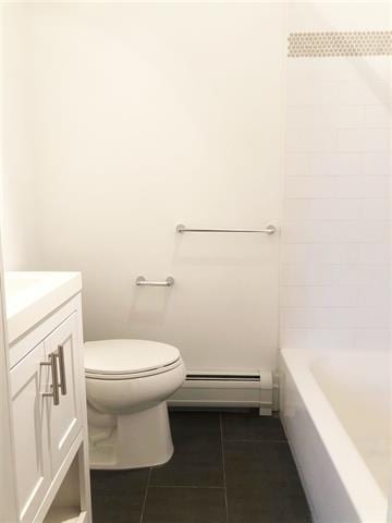 24 E 49th St, Bayonne, NJ 07002 - bathroom with a baseboard heating unit, tile patterned flooring, vanity, and toilet
