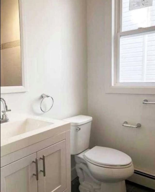24 E 49th St, Bayonne, NJ 07002 - half bath featuring baseboard heating, vanity, and toilet