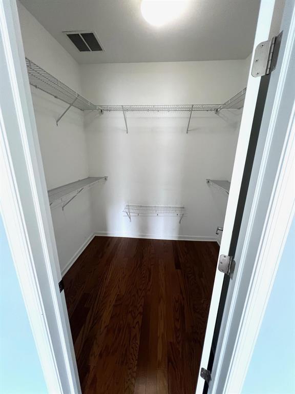 spacious closet featuring hardwood / wood-style floors