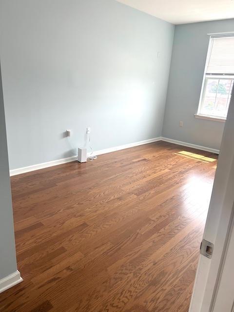 empty room featuring dark hardwood / wood-style floors