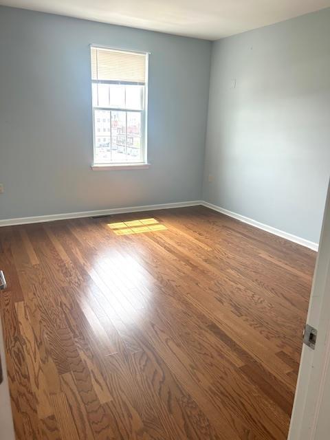 unfurnished room featuring dark hardwood / wood-style floors