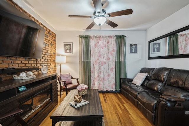 living room featuring ceiling fan and light hardwood / wood-style flooring