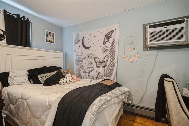 bedroom with an AC wall unit, hardwood / wood-style flooring, and a baseboard radiator