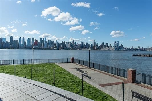 water view with fence and a city view