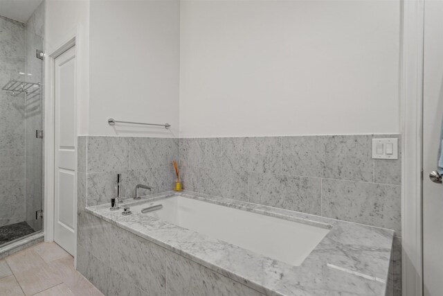bathroom with a garden tub and a stall shower