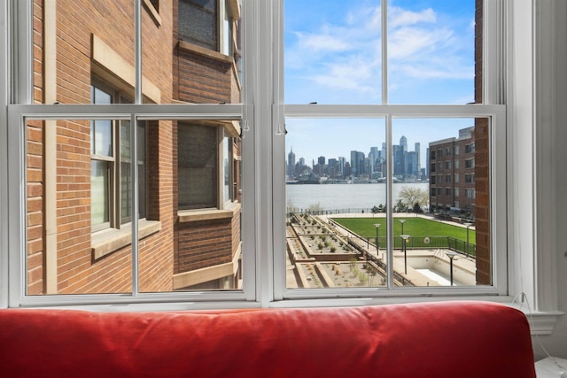 entryway with a wall of windows, a view of city, and a water view