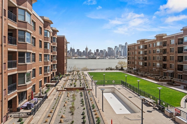 exterior space with a water view and a city view