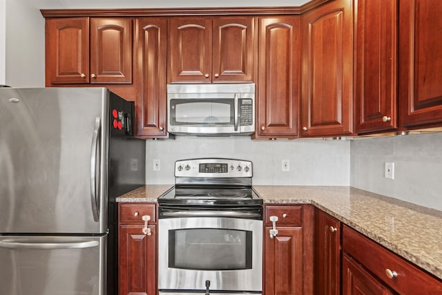 kitchen featuring backsplash, light stone counters, and appliances with stainless steel finishes