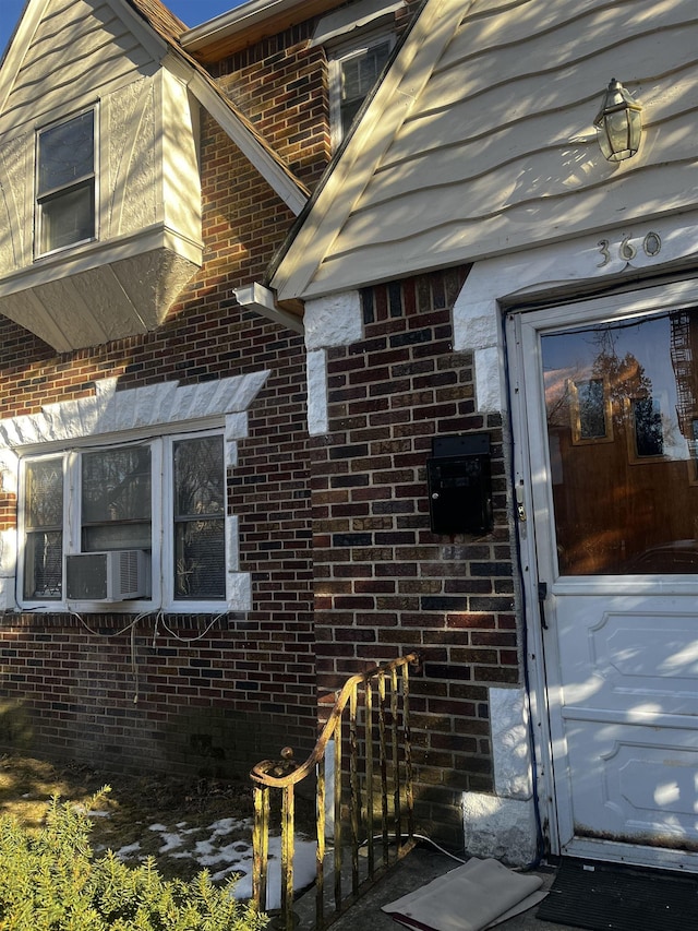 view of exterior entry with brick siding