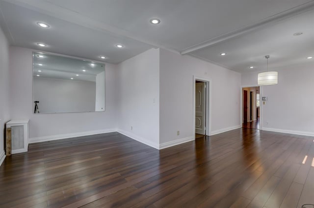 empty room featuring recessed lighting, dark wood-style flooring, and baseboards