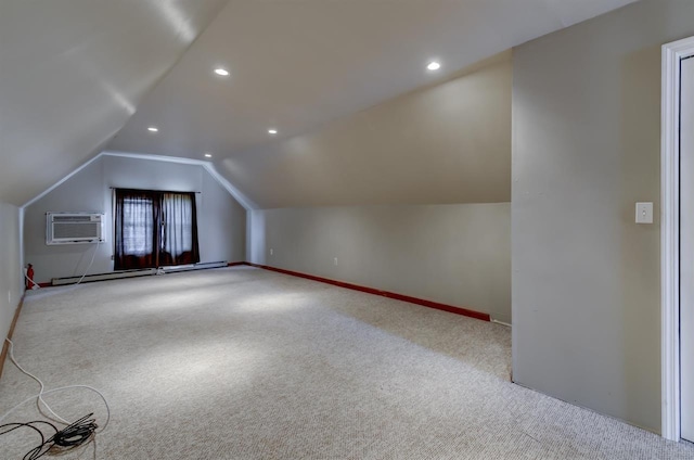 bonus room with a baseboard radiator, an AC wall unit, carpet flooring, and vaulted ceiling