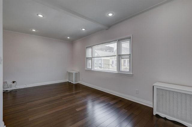 spare room featuring hardwood / wood-style floors, radiator, baseboards, beam ceiling, and recessed lighting