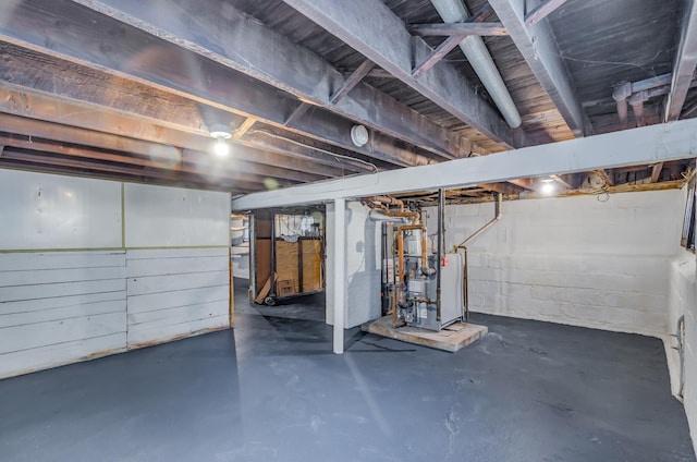 unfinished basement featuring a heating unit