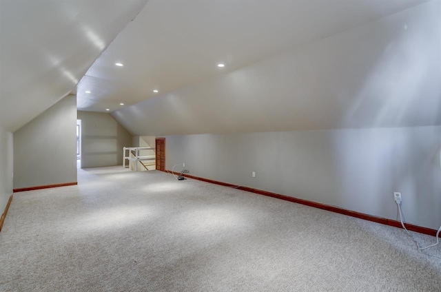 additional living space with vaulted ceiling, recessed lighting, baseboards, and carpet floors