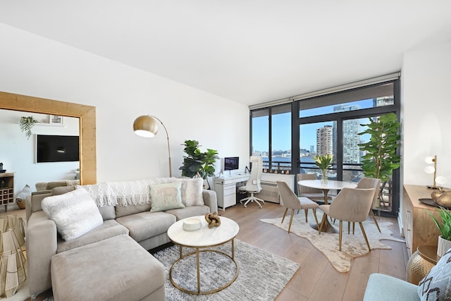 living area featuring wood-type flooring and expansive windows