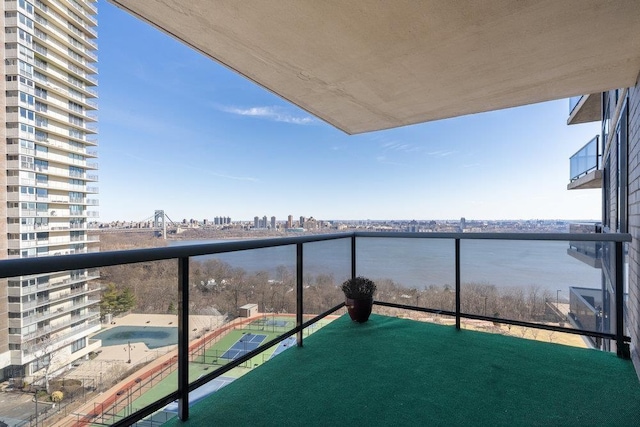 balcony with a view of city and a water view