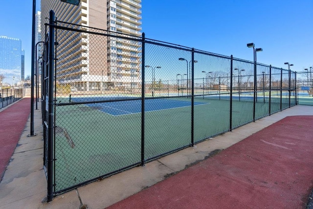 view of sport court with fence