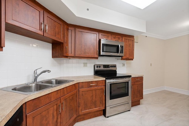 kitchen featuring light countertops, backsplash, appliances with stainless steel finishes, and a sink