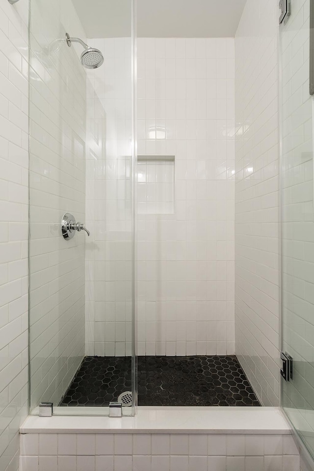 bathroom with a shower with door