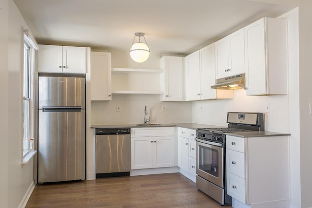 kitchen with white cabinets, sink, hanging light fixtures, dark hardwood / wood-style flooring, and stainless steel appliances