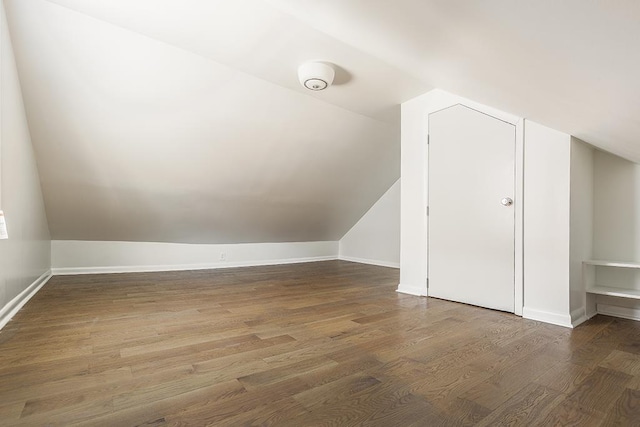 bonus room with dark hardwood / wood-style floors and lofted ceiling