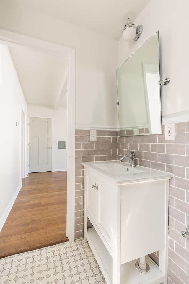 bathroom featuring vanity and tile walls