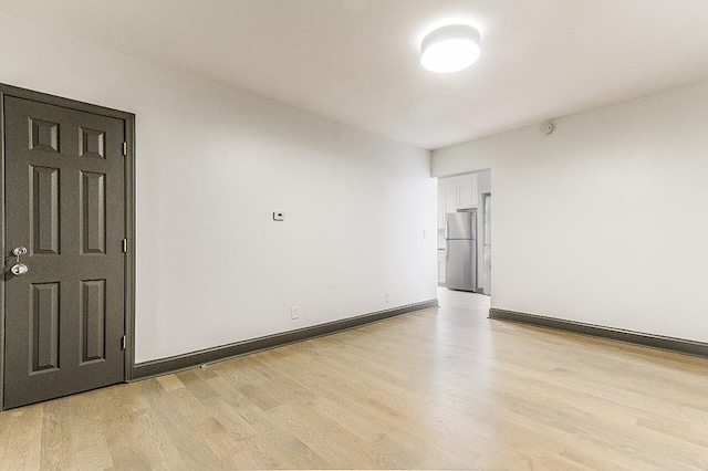 unfurnished room with light wood-type flooring