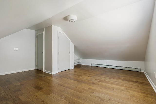 bonus room featuring hardwood / wood-style floors, a baseboard radiator, and lofted ceiling