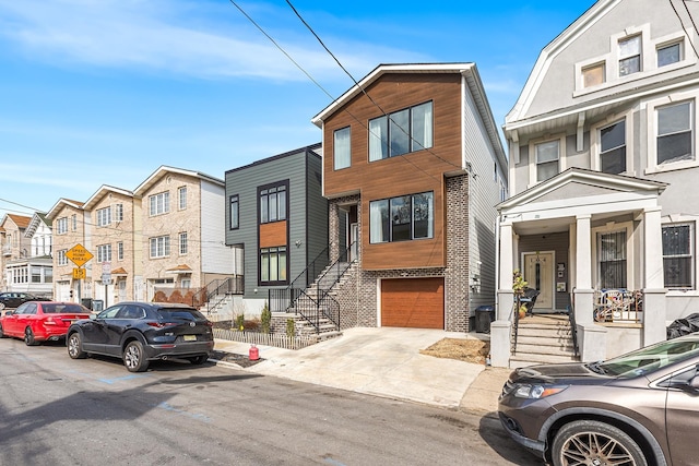 multi unit property with concrete driveway and a garage