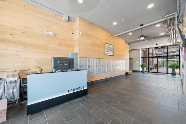 300 Communipaw Ave Unit 11, Jersey City, NJ 07304 - reception with wooden walls, recessed lighting, mail area, and a ceiling fan
