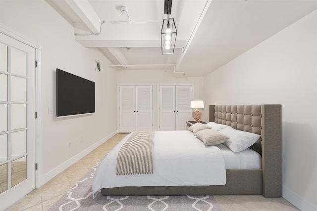 300 Communipaw Ave Unit 11, Jersey City, NJ 07304 - bedroom featuring multiple closets, light tile patterned floors, and baseboards
