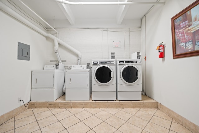 300 Communipaw Ave Unit 11, Jersey City, NJ 07304 - communal laundry room featuring washing machine and dryer, light tile patterned floors, and electric panel
