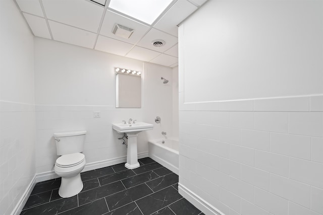 300 Communipaw Ave Unit 11, Jersey City, NJ 07304 - bathroom with toilet, tile walls, tile patterned flooring, shower / bathtub combination, and wainscoting