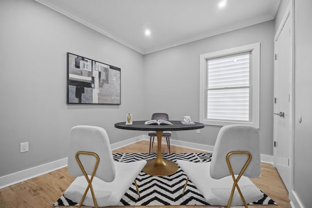 office area with crown molding and light hardwood / wood-style floors