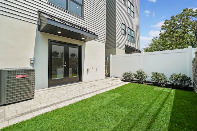 view of yard featuring french doors and cooling unit