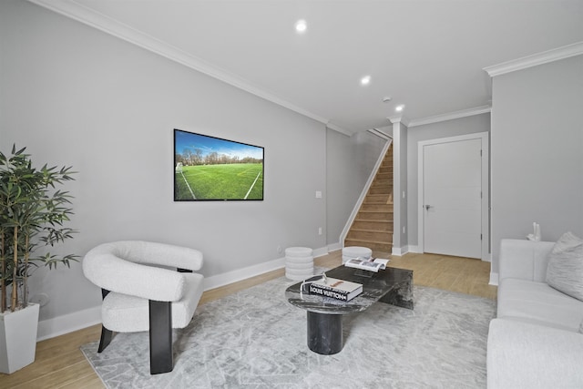 living room featuring wood-type flooring and crown molding