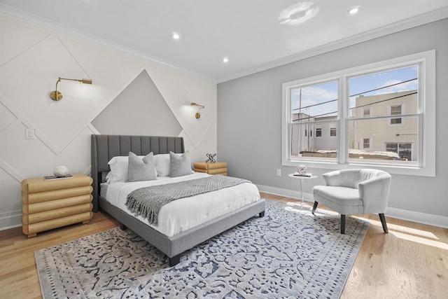 bedroom with light wood-type flooring and crown molding