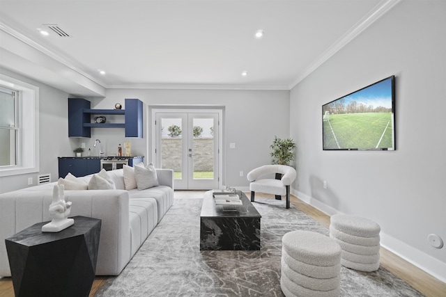 living room with crown molding, french doors, hardwood / wood-style floors, and indoor wet bar