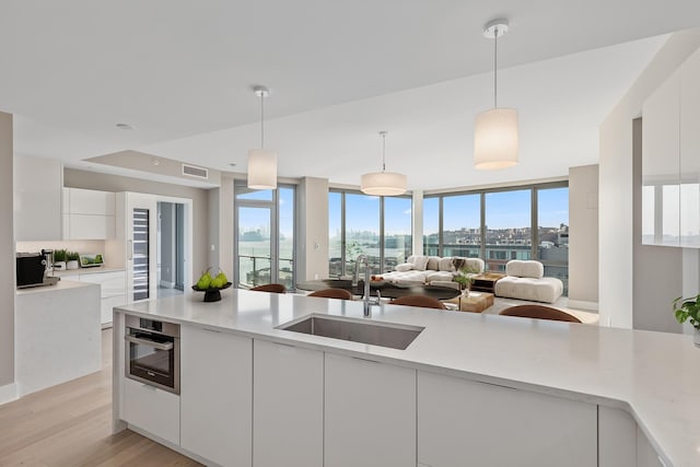 9 Avenue At Port Imperial Unit Ph8, West New York, NJ 07093 - kitchen featuring modern cabinets, white cabinetry, light countertops, and light wood finished floors