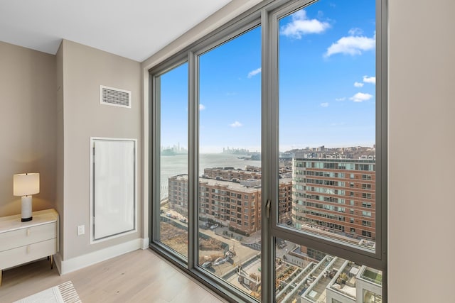 9 Avenue At Port Imperial Unit Ph8, West New York, NJ 07093 - empty room featuring wood finished floors, a water view, and a city view