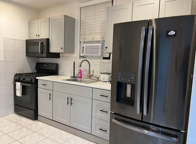 1611 71st St, North Bergen, NJ 07047 - kitchen featuring stainless steel fridge with ice dispenser, black gas range, light countertops, light tile patterned floors, and tasteful backsplash
