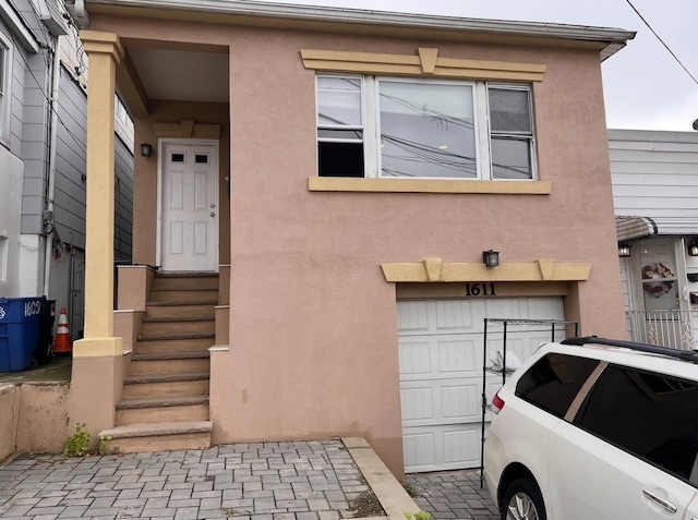 1611 71st St, North Bergen, NJ 07047 - townhome / multi-family property with stucco siding and a garage
