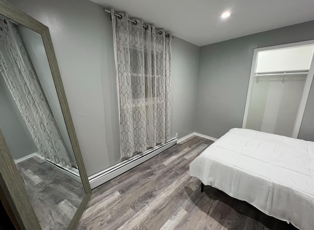 1611 71st St, North Bergen, NJ 07047 - bedroom featuring wood finished floors, baseboard heating, a closet, and recessed lighting