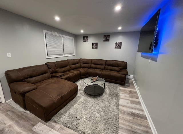 1611 71st St, North Bergen, NJ 07047 - living area with recessed lighting, light wood-style floors, and a baseboard heating unit