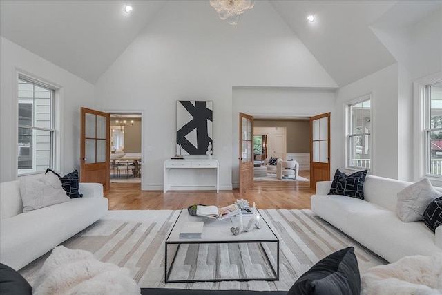 180 Union St, Montclair, NJ 07042 - living room featuring high vaulted ceiling, wood finished floors, a chandelier, and wainscoting