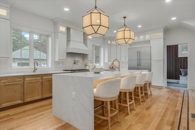 180 Union St, Montclair, NJ 07042 - kitchen featuring premium range hood, light countertops, tasteful backsplash, an island with sink, and recessed lighting