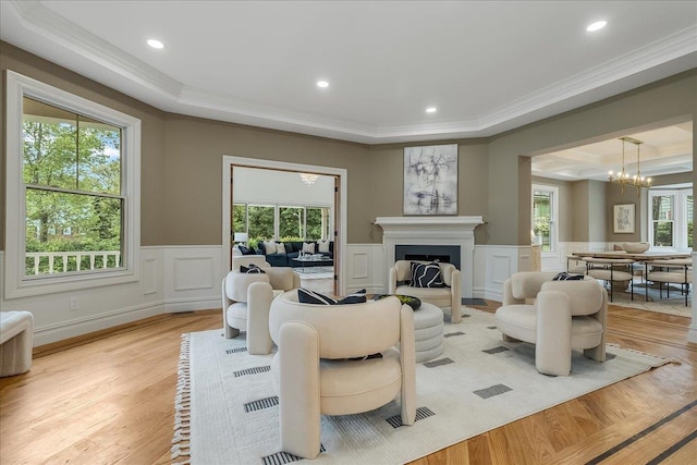 180 Union St, Montclair, NJ 07042 - living room with ornamental molding, a chandelier, healthy amount of natural light, light wood-style floors, and wainscoting